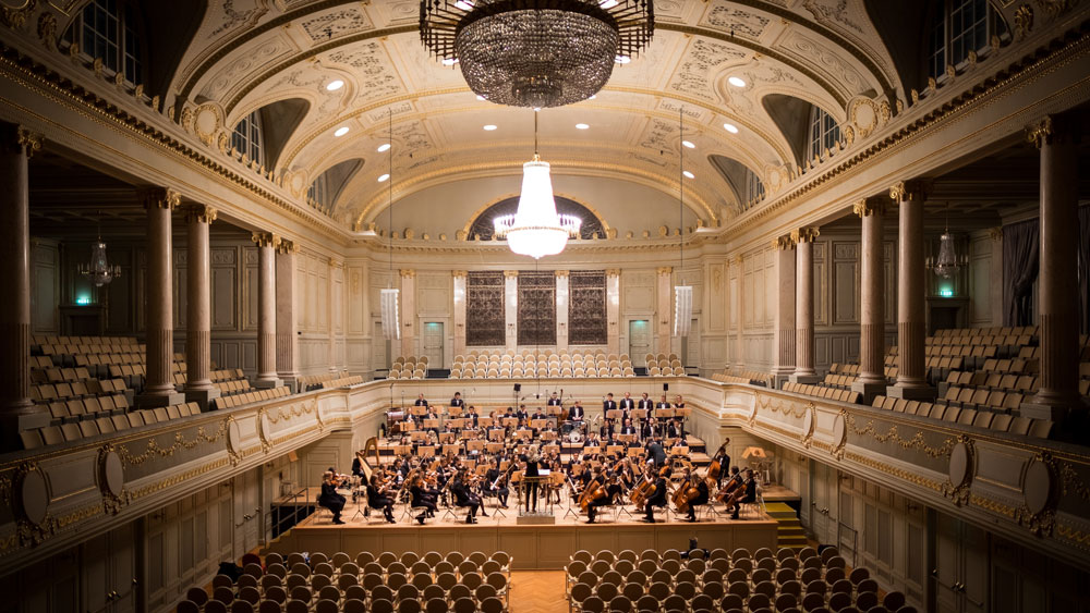 an orchestra plays in an intricate building