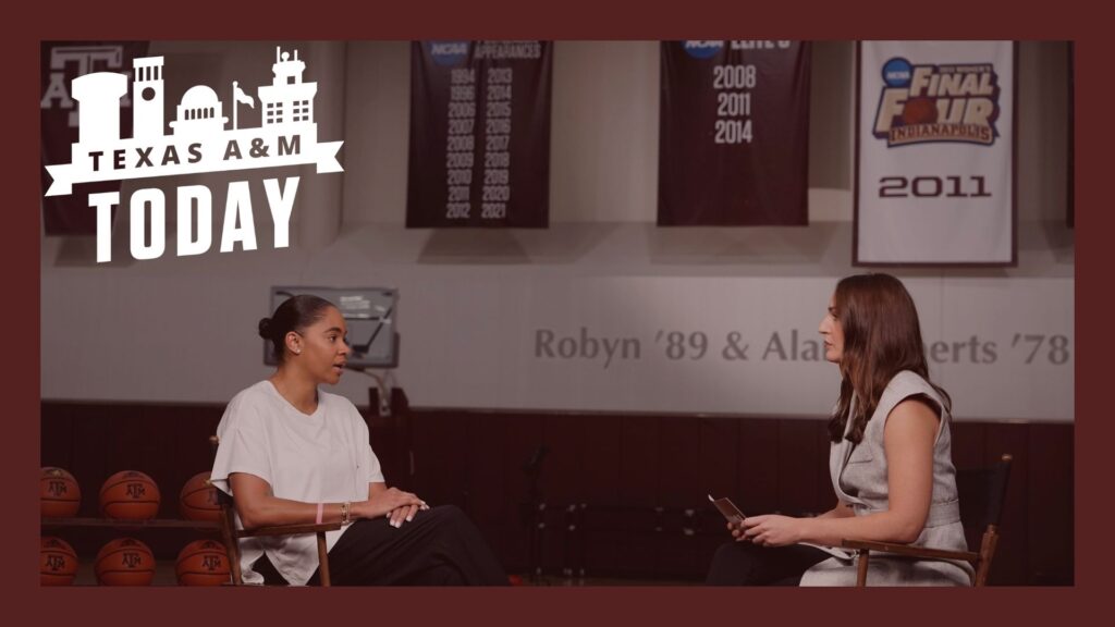 Joni Taylor talks to Chelsea Reber in a basketball gym.