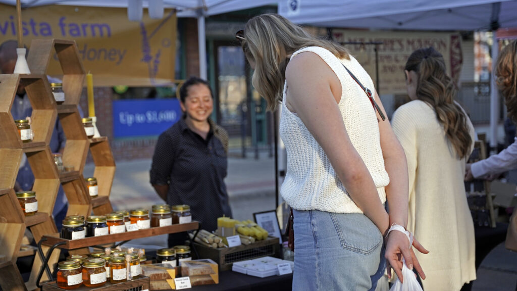 Vendor talking to shopper at First Friday