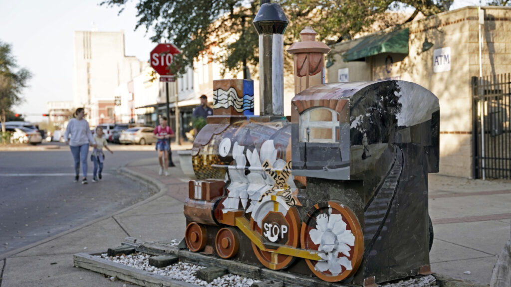 Statue of train on sidewalk of Downtown Bryan