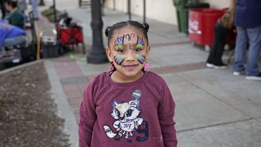 Young visitor with butterfly face paint