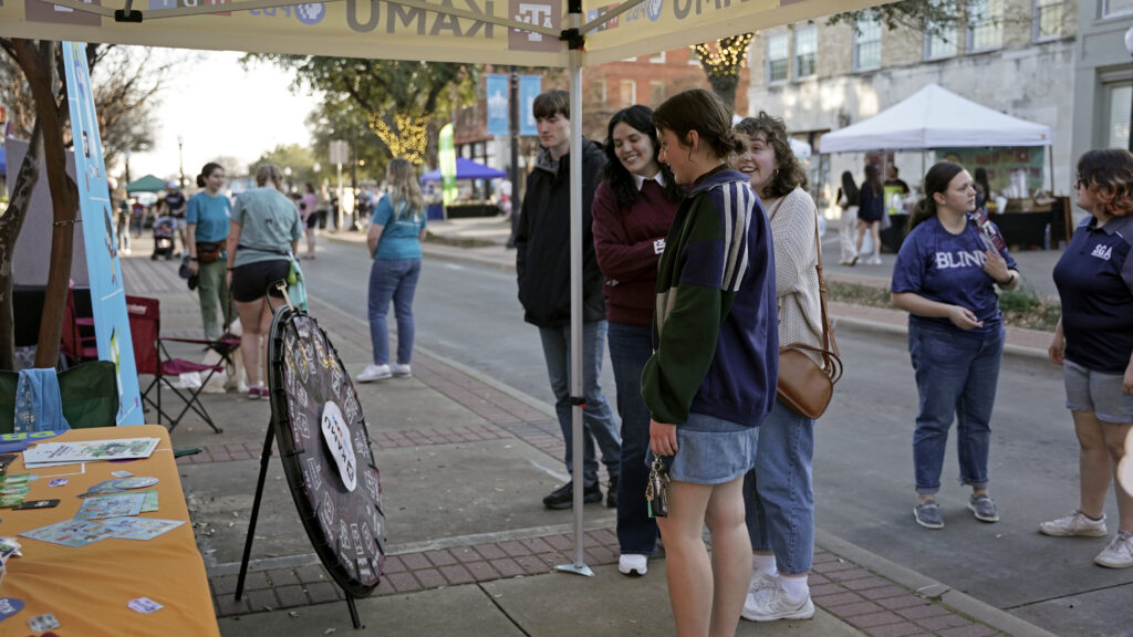 First Friday guest spinning the KAMU prize wheel