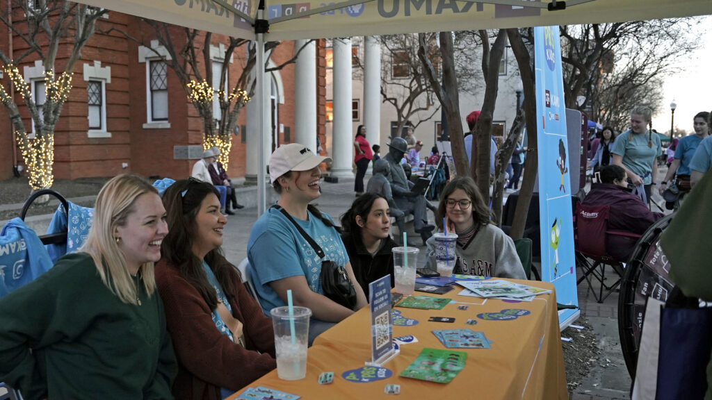 KAMU team chatting with First Friday guest