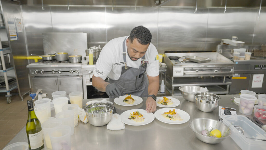 Chef Demetrius puts the finishing touches on his plate.