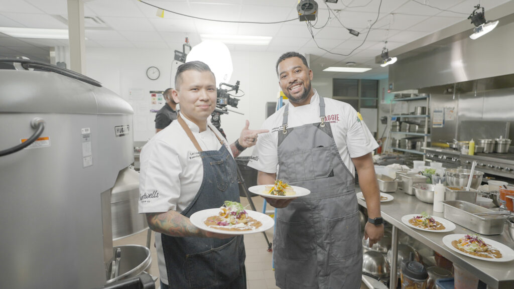 Chefs Leo and Demetrius pose with their finished dishes.