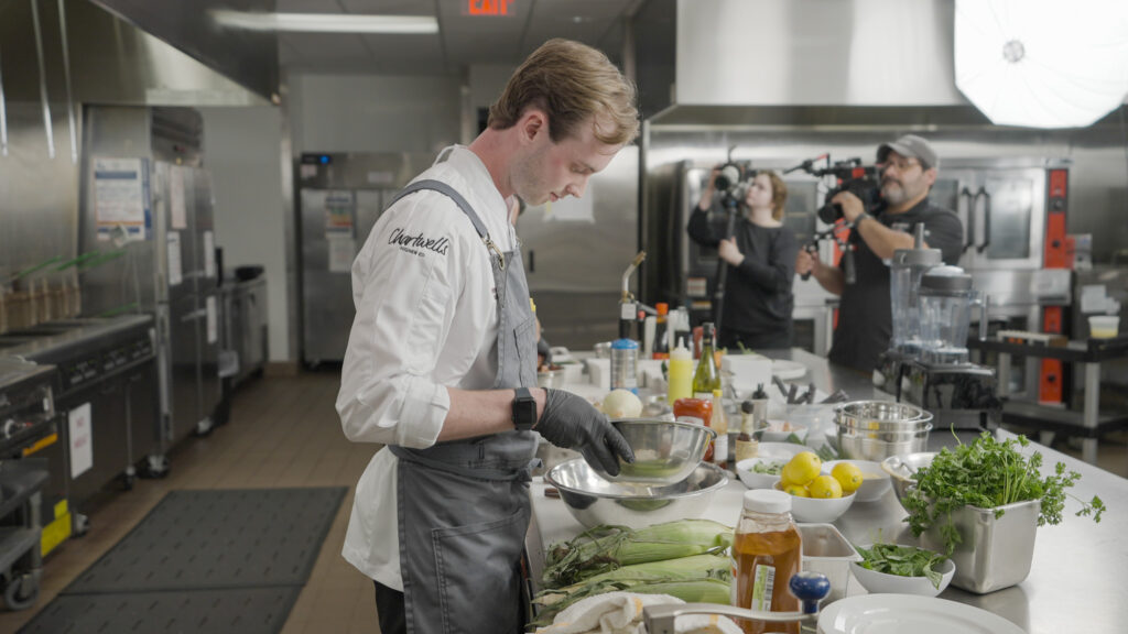 Chef Will mixes his sauce.