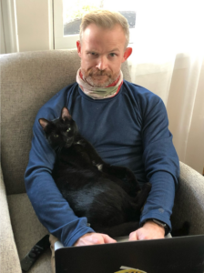 Dr. Dustin Major with his cat, Ron Swanson.