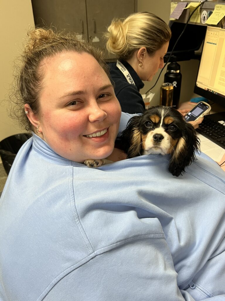 Dr. Kendra Zelachowski with her dog, Delta, tucked into her shirt.