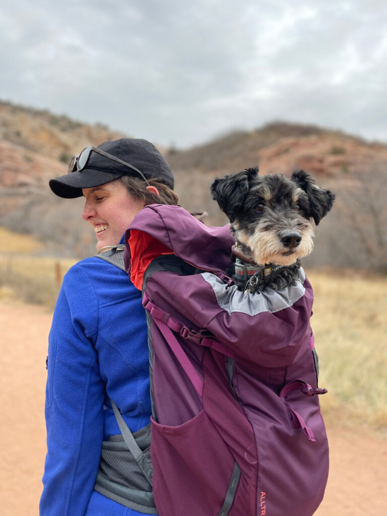 Dr. Shayna Doyle with her dog, Ezra, tucked into a backpack.