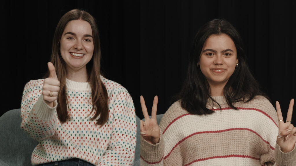 Former KAMU student employees Hannah and Maria smile at the camera.